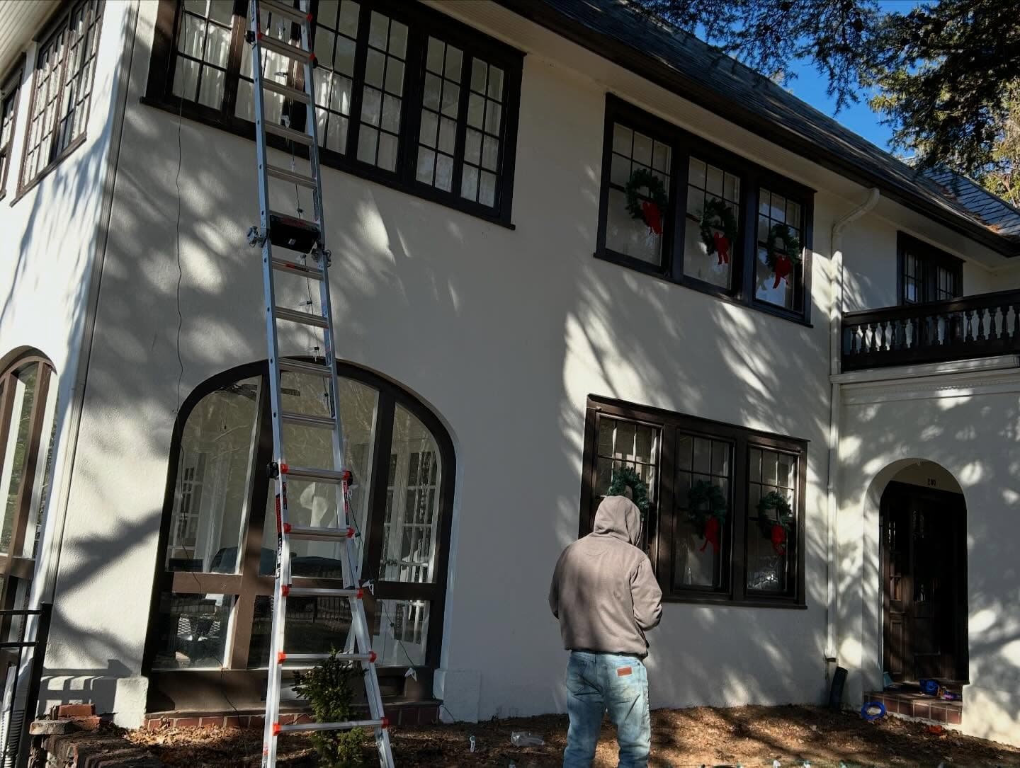 Chet cleaning the windows of a home in Austin